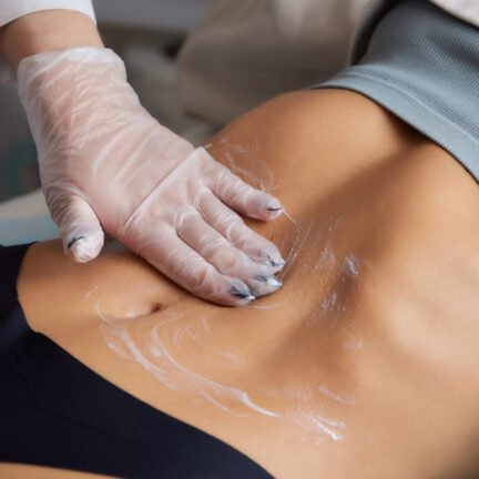 procedure removing cellulite on female abdomen, cavitation belly massage. Ultrasonic massage for weight loss. Correction of female figure without surgical intervention. Closeup of the tummy